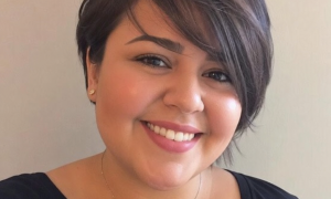 Woman with a beautiful chubby face long pixie cut smiling brightly